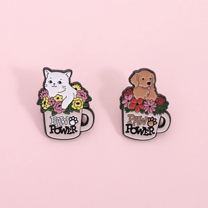 Cute set of two enamel pins featuring cat and dog in flower mugs with Paw Power text