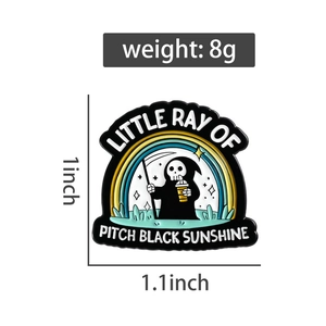 Detail of reaper enamel pin with rainbow and Little Ray of Pitch Black Sunshine text