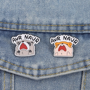 Cartoon screaming raccoon and hamster enamel pins set on denim fabric background