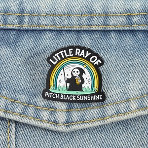 Grim Reaper coffee badge with rainbow design on a blue denim jacket pocket