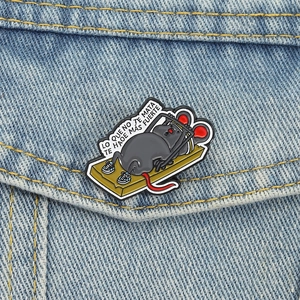 Cartoon mouse weightlifting on a golden trap enamel pin on a blue denim jacket