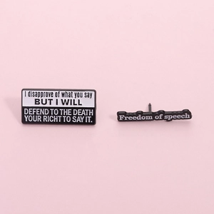 Set of two black and white enamel pins with freedom of speech quotes on a pink background