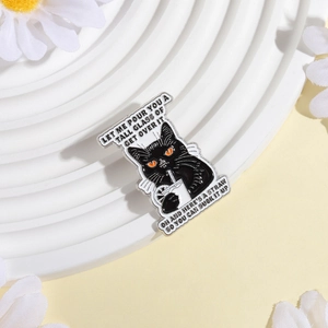 Detail of funny black cat enamel pin with sarcastic quote and silver metal edge