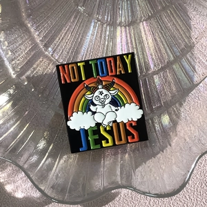 Macro detail of 'Not Today Jesus' rainbow enamel pin with cartoon goat on cloud