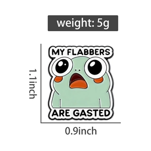 Detail view of cartoon frog enamel pin with 1.1x0.9 inch dimensions and weight