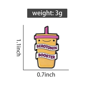 Detail view of a yellow serotonin booster pin showing dimensions of 1.1 x 0.7 inches