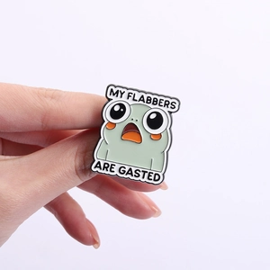 Green cartoon monster enamel pin with humorous My Flabbers Are Gasted quote