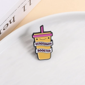 Yellow enamel pin featuring a serotonin booster drink design with purple lid and straw
