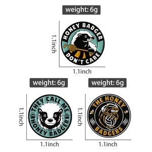 Detail of round honey badger enamel pins showing 1.1-inch size and 6g weight specs