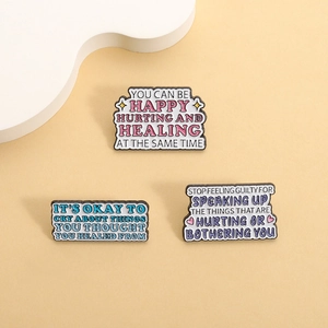 Set of three mental health enamel pins with inspirational quotes on beige background