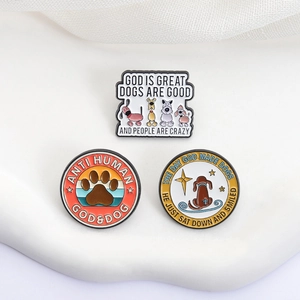Set of three dog-themed enamel pins featuring cartoon illustrations and paw prints on white base