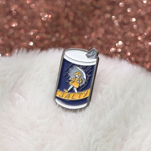 Cute cartoon enamel pin of a girl with yellow raincoat and Salty text on white fur