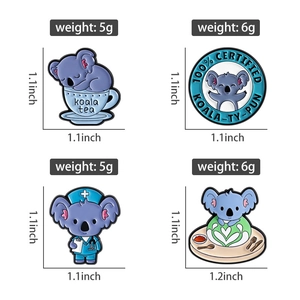 Detail view of four cute blue koala enamel pins showing sizes and 1.1 inch dimensions