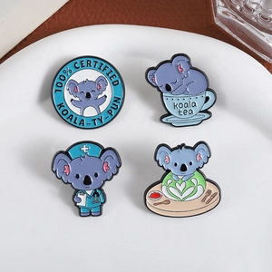 Cute set of four enamel koala lapel pins with nurse and tea designs on a white plate