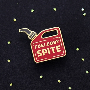 Red gas can enamel pin with gold trim featuring Fueled by Spite text for clothing