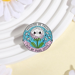 Round enamel angry dandelion brooch with Hanging In There text and floral props
