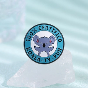 Round blue enamel pin with cartoon koala and 100% Certified Koala-ty-pun text decoration