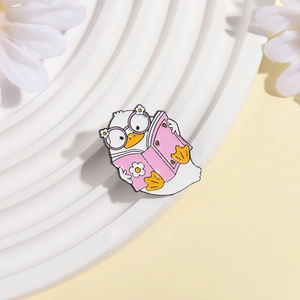 Cute pink book reading duck enamel pin with daisy glasses on a ceramic plate