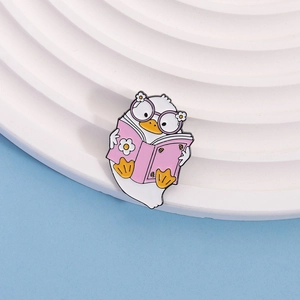 Cute cartoon duck reading book enamel pin with purple glasses on white podium