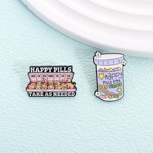 Enamel pin set with pink Happy Pills dog schedule and purple rainbow pill bottle badge