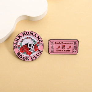 Pink enamel pins set with skull rose design and Dark Romance Book Club ticket emblem