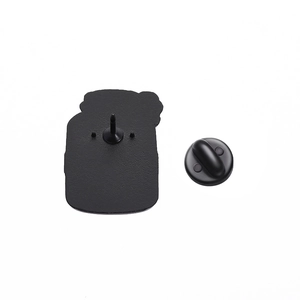 Detail view of the black enamel pin back with rubber clutch and sharp needle pin buckle