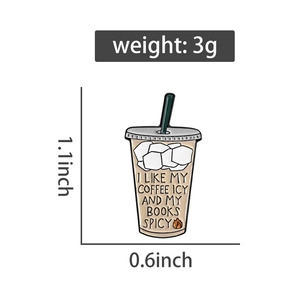 Detailed view of enamel coffee cup pin with Icy Coffee and Spicy Books slogan
