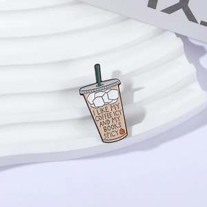 Enamel coffee cup brooch with funny text and green straw on a white display stand