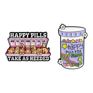 Set of happy pills enamel pins featuring puppies and motivational bottle on white base