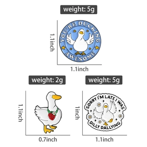 Detailed view of three cute duck enamel pins with size and weight measurement labels