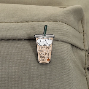 Detail of coffee cup enamel pin on canvas bag with I Like My Coffee Icy text