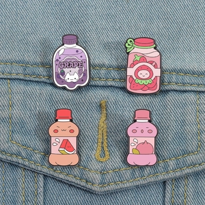 Detail showing four fruit theme enamel pins on denim jacket featuring cute drink bottle designs