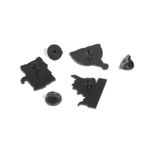 Detail view of the black metal backplate and rubber clutches for enamel pin badges