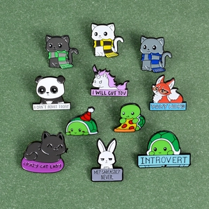 Cartoon animal enamel pins set featuring unicorn, turtle and panda badges on green surface