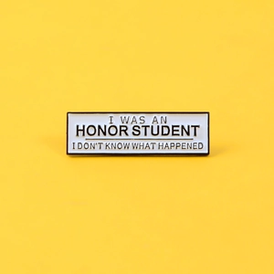 Funny Honor Student enamel pin badge with humorous quote on bright yellow background