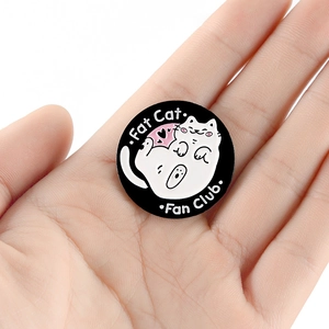 Fat Cat Fan Club enamel pin with cute cartoon white cat on black round metal badge