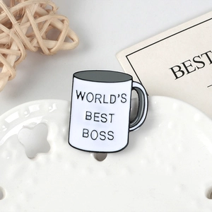 World's Best Boss white coffee mug enamel pin badge on a decorative ceramic tray