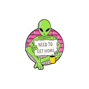Cartoon green alien enamel pin holding a 'NEED TO GET HOME' sign on purple background