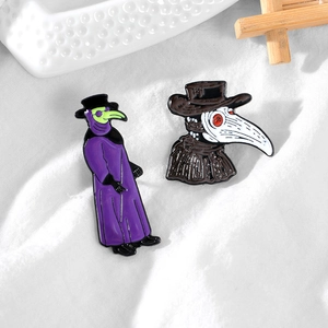 Detailed view of two medieval plague doctor enamel pins in gothic punk art style