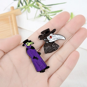Detail of two plague doctor enamel pins in purple and black cloaks with gothic masks