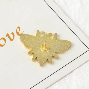 Vue arrière d'une broche abeille en émail doré avec finition mate et épingle de fixation