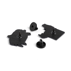 Rear view of game console enamel pins showing metal backing and rubber clutch fasteners
