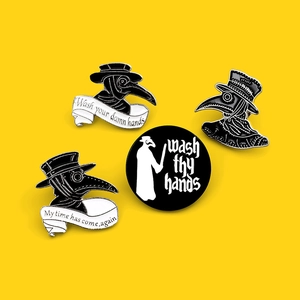 Set of four Plague Doctor enamel pins with Wash Your Damn Hands text on yellow background