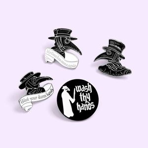 Set of four black enamel plague doctor pins with My Time Has Come Again typography