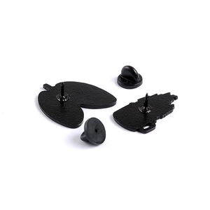 Lung shaped enamel pin back with black rubber clutches on a plain white background