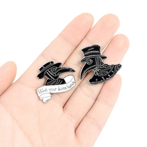 Cartoon plague doctor enamel pins featuring Wash your damn hands slogan on white background