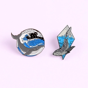 Cartoon whale enamel pins set featuring wave patterns in round and diamond metal frames