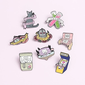 Detail view of retro pastel enamel pins set featuring gaming consoles and cartoon icons
