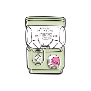 Detail of mint green gashapon machine enamel pin with positive quote and the one text
