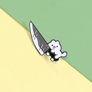 Detail of creative cartoon white cat enamel pin holding a kitchen knife accessory